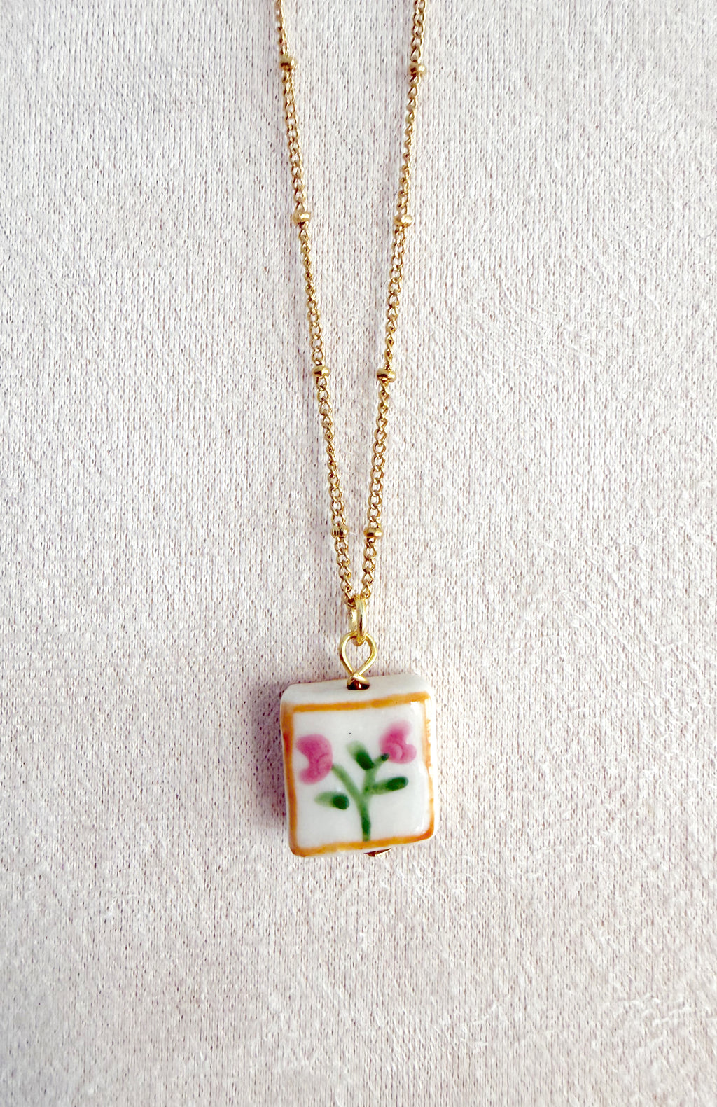 Cadena acero con florecitas en cerámica 🌷